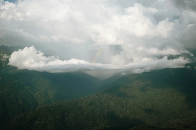 some very pretty clouds with a rainbow in the sky