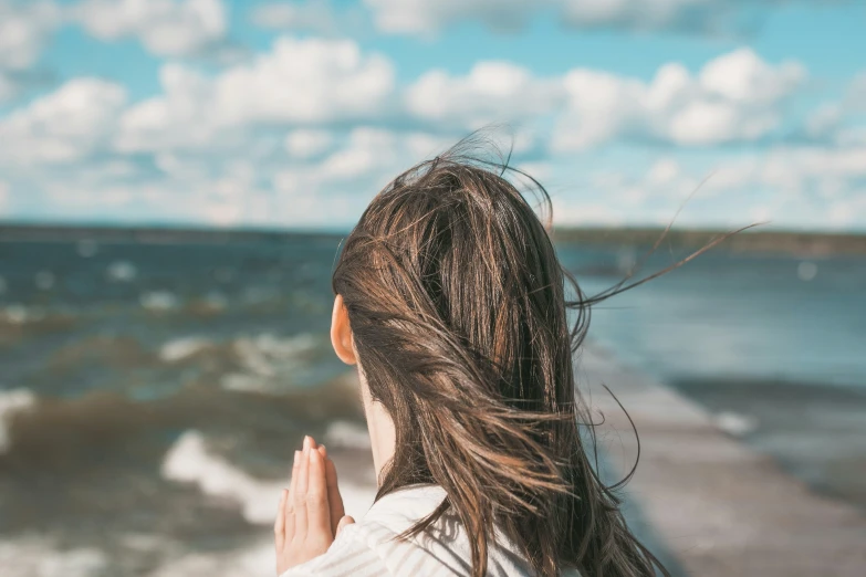 a  is praying at the edge of the water