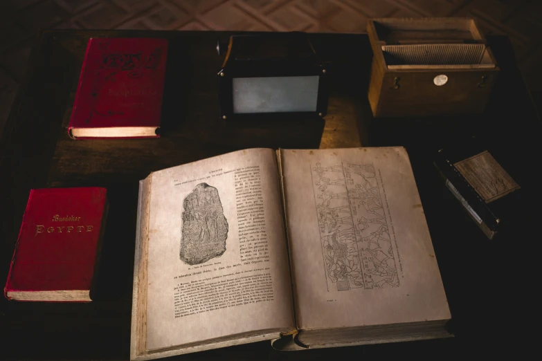 a desk with several books and a microscope