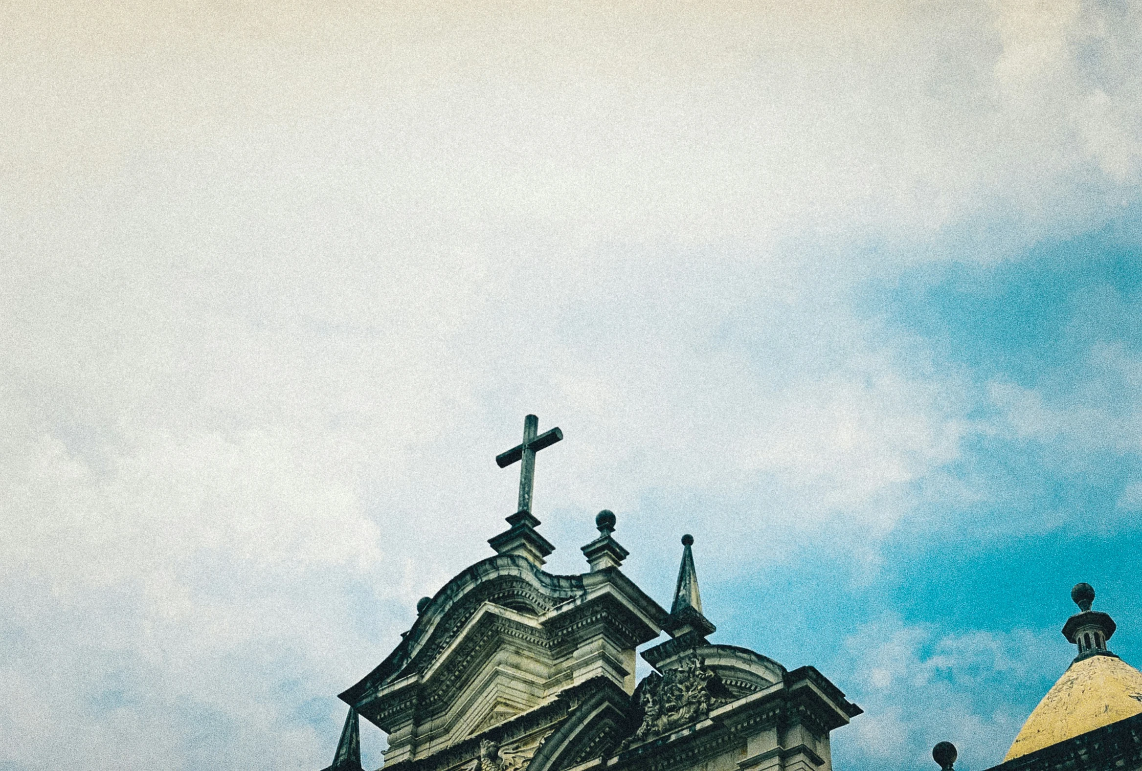 a church steeple with a crucifix atop the top