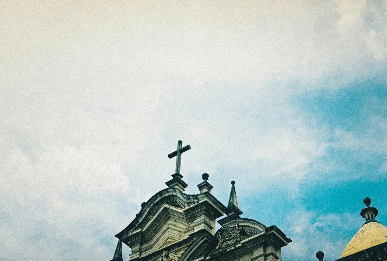 a church steeple with a crucifix atop the top