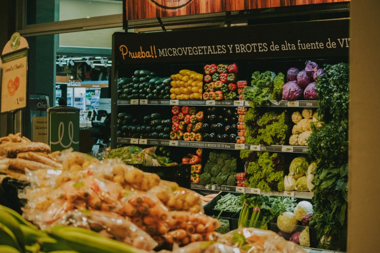 an assortment of fruits and vegetables displayed at a supermarket