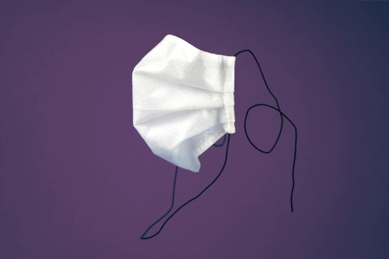 a medical mask, with wires on purple background