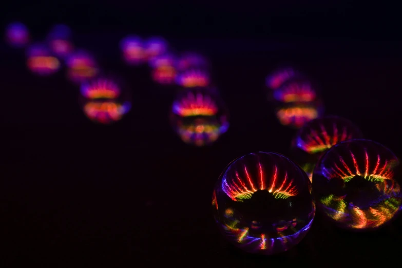 a black background has lights reflecting from bubbles