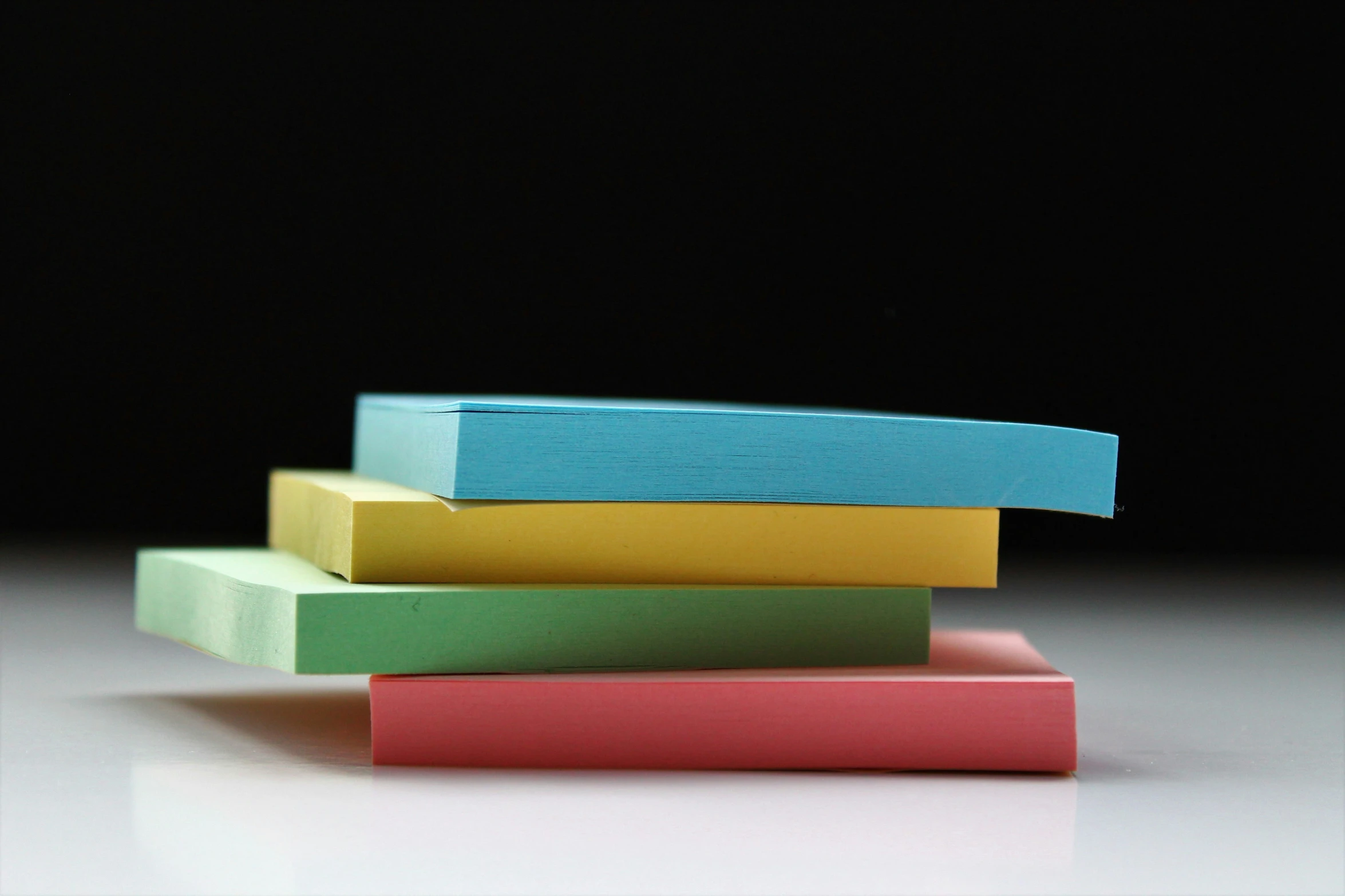 four square erasers are stacked side by side on a table