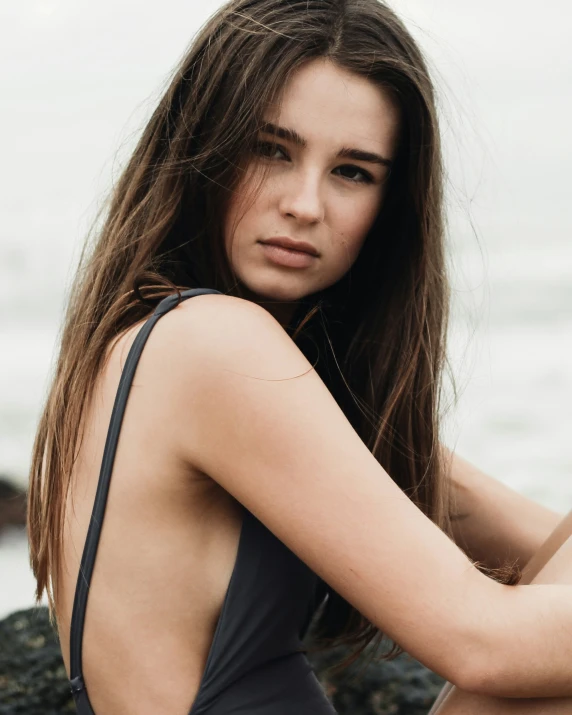 a girl in a bathing suit near the water