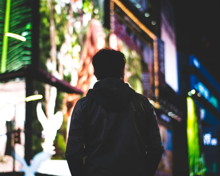 a young man standing in front of a building