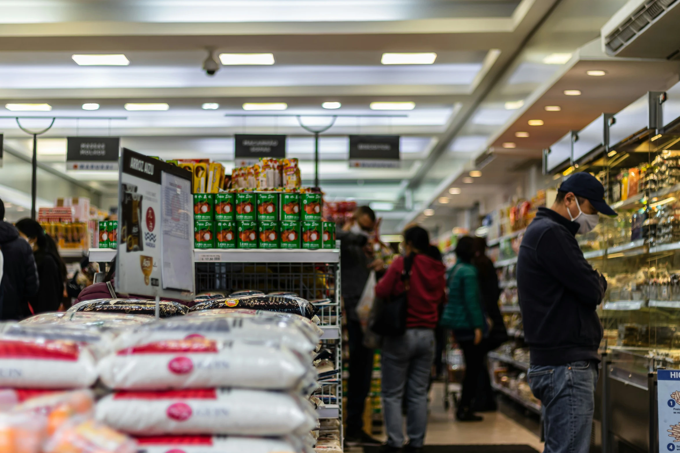 people browse through a large supermarket store