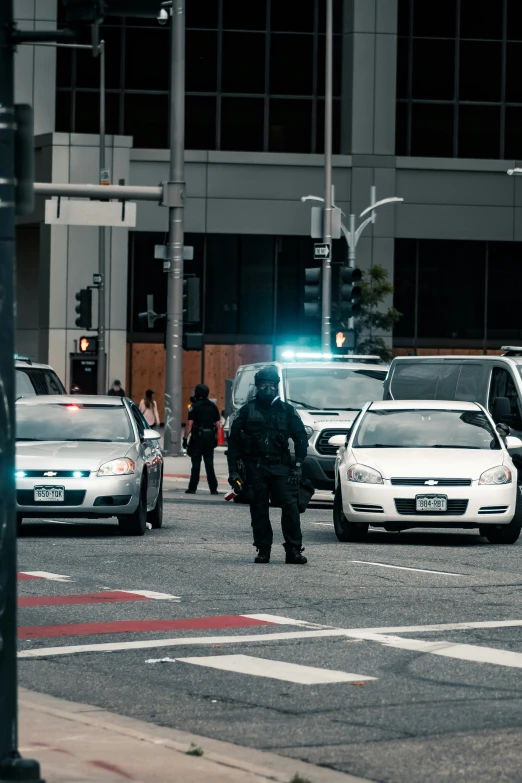 a policeman directing traffic as cars are in motion