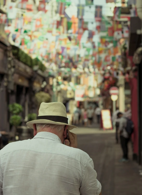 a man walking down a street talking on a phone