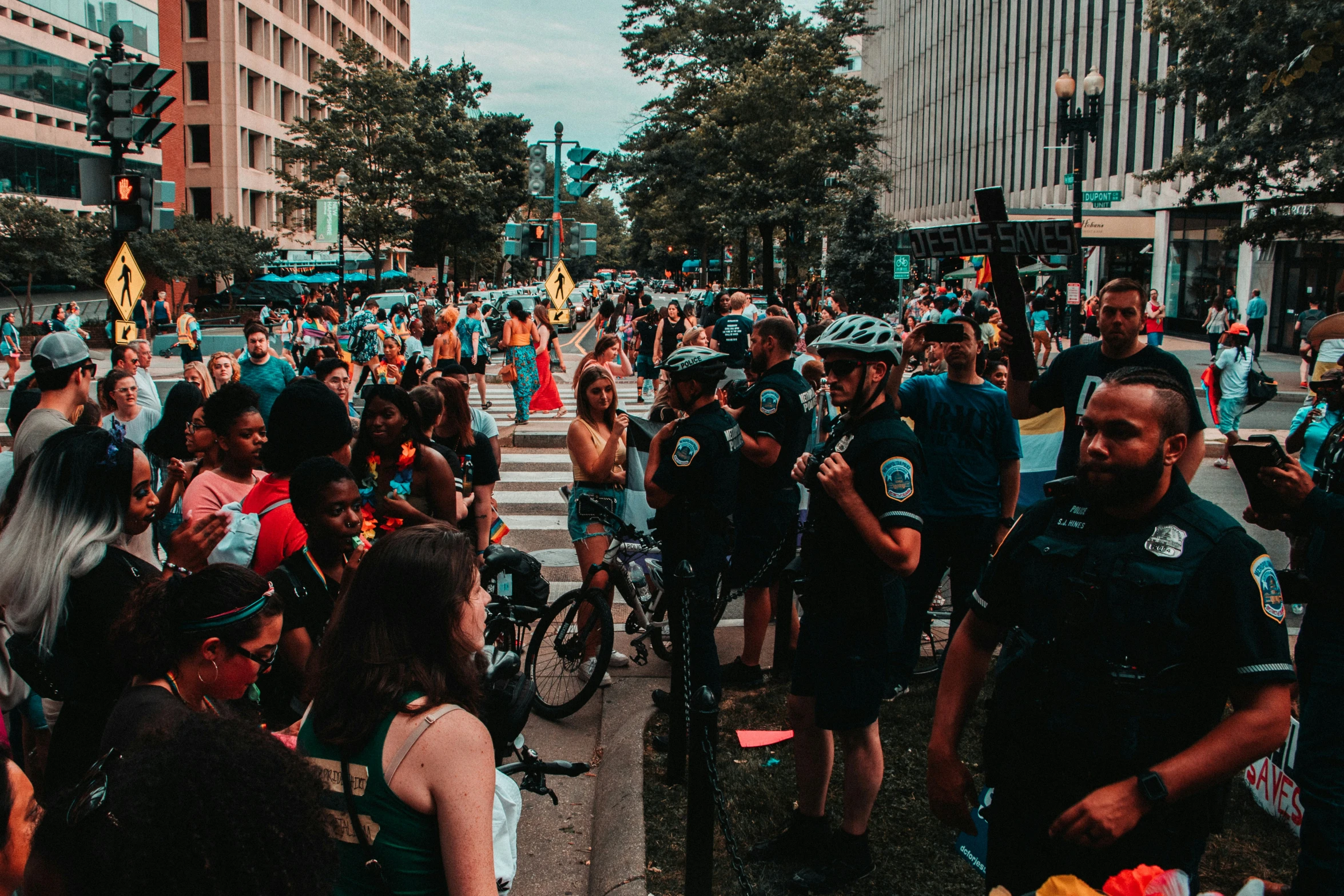 a street crowded with people wearing police gear