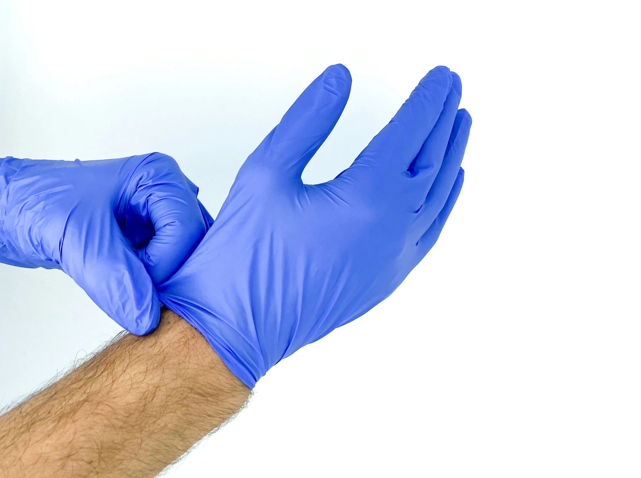 an adult holding a blue glove up to show the hand in blue