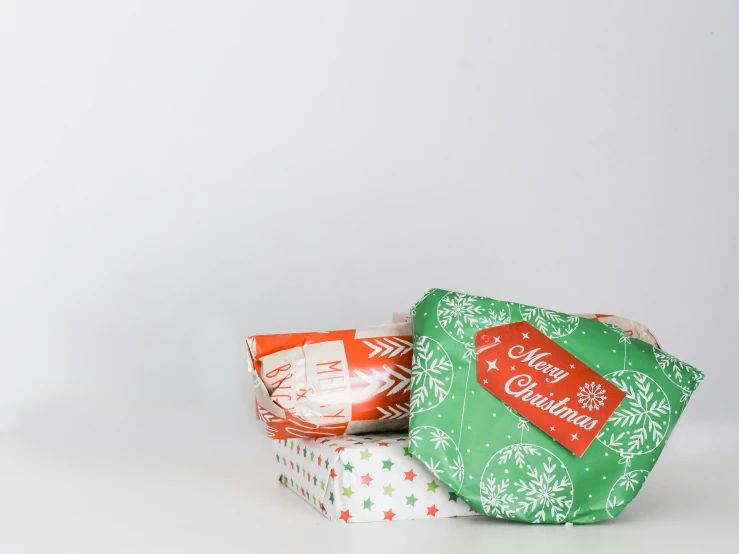 three wrapped presents in various patterns and colors