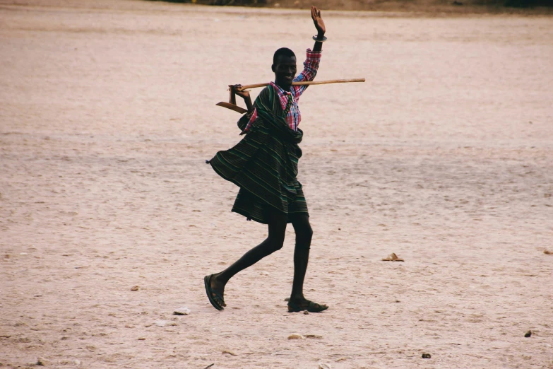 a man in black dress dancing with a stick