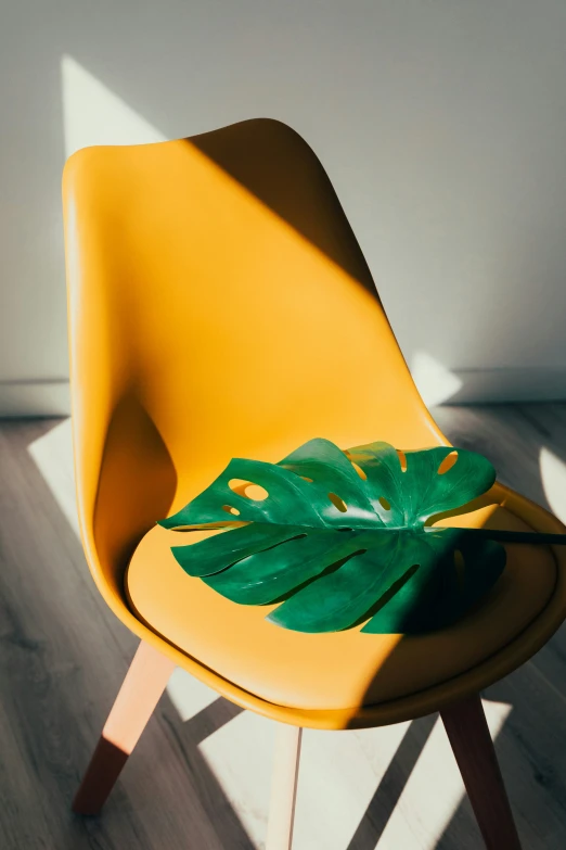 an orange chair with a banana leaf on it