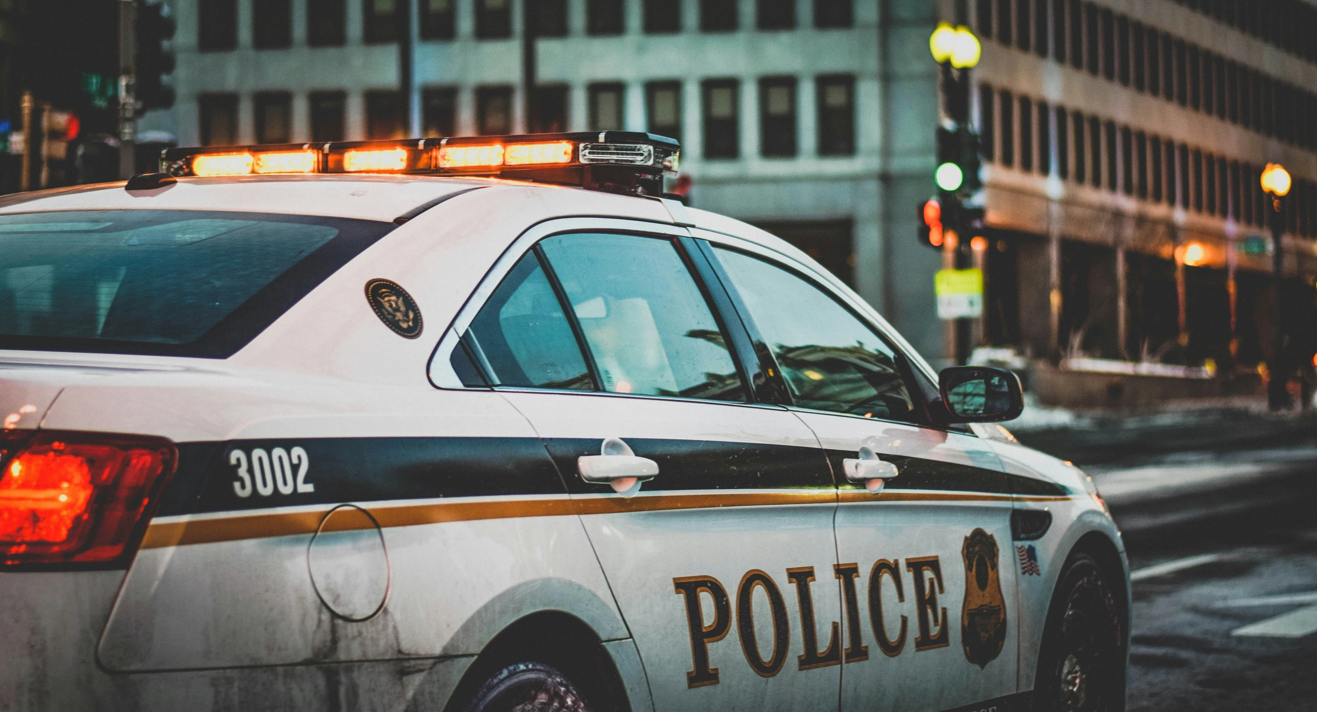 an ambulance stopped at a red light near a street