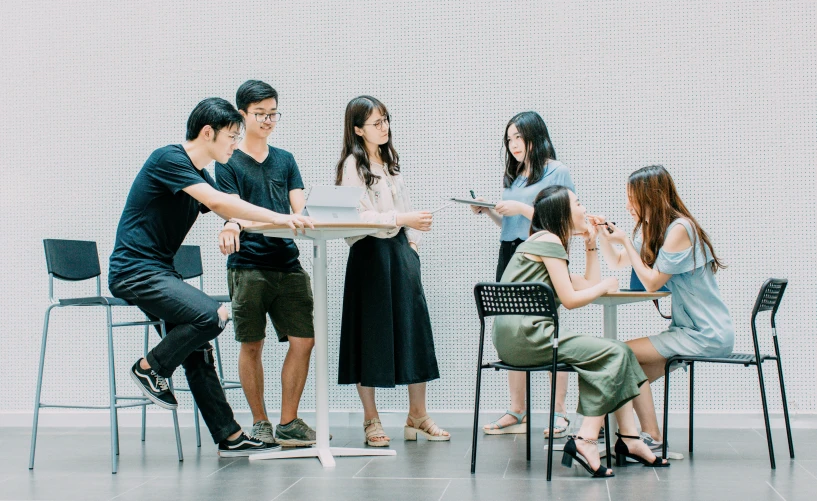 four people sitting around a table with each others