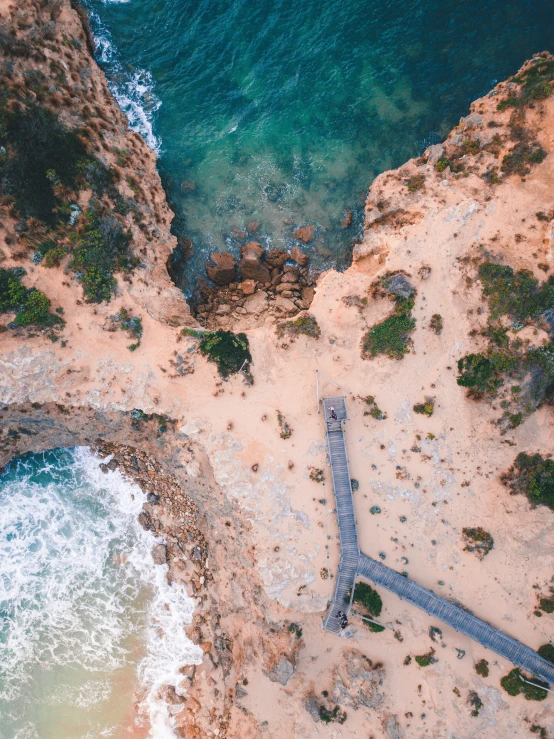 a bird's eye view of a sandy beach and ocean