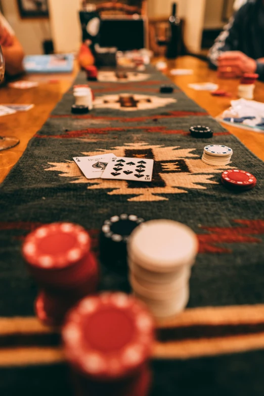 people are playing cards at a poker table