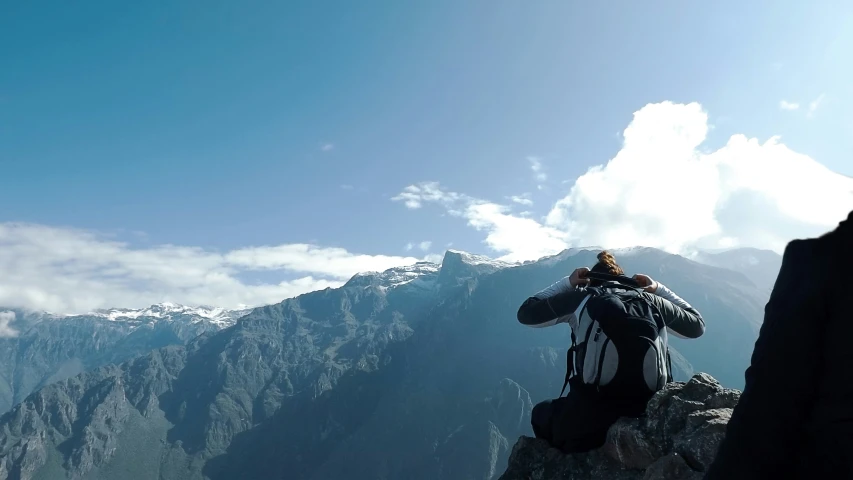 a man taking a po of the top of a mountain