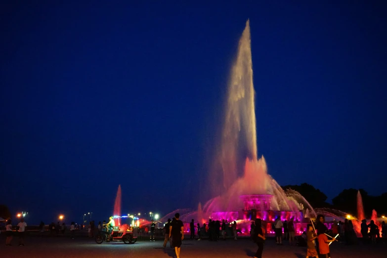 the people are enjoying the illuminated water show