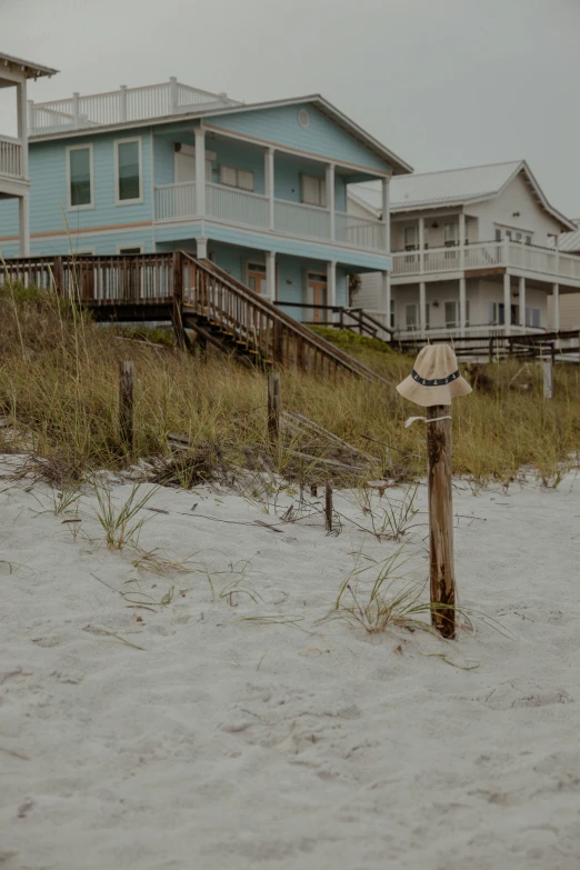 a row of beach houses with a sky background