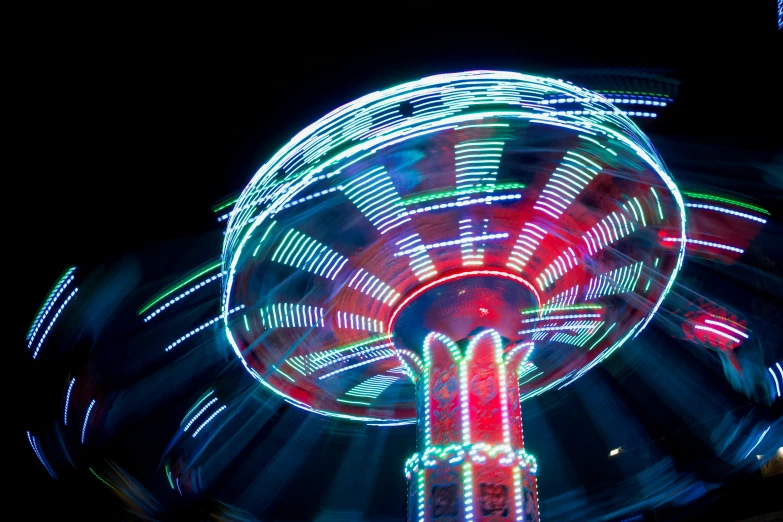 a close up of a carnival ride at night