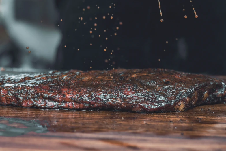 steak is grilled on the grill while being seasoned