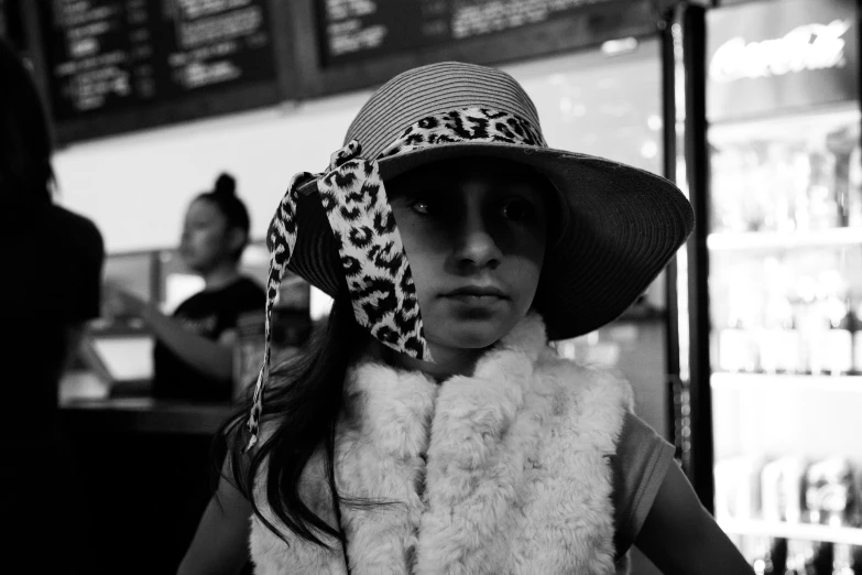 a little girl in a hat and scarf