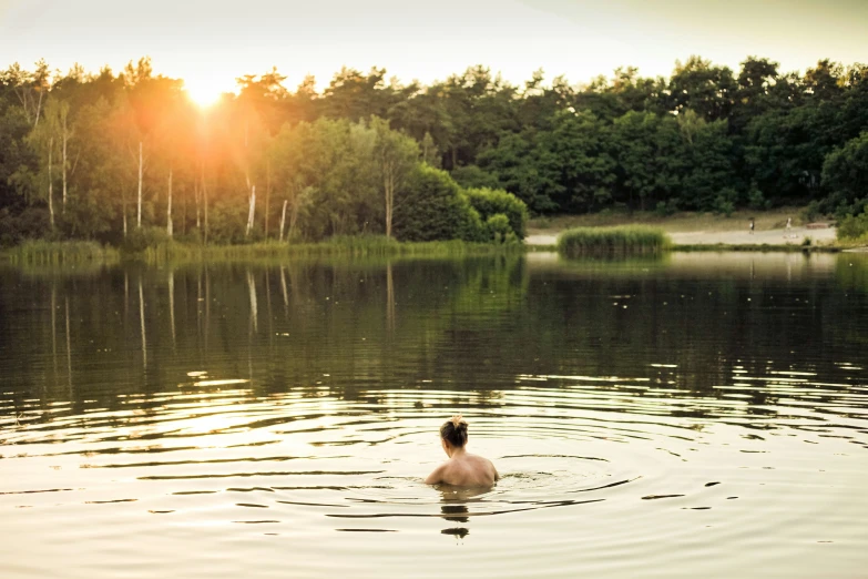 a lone person swims in a large body of water