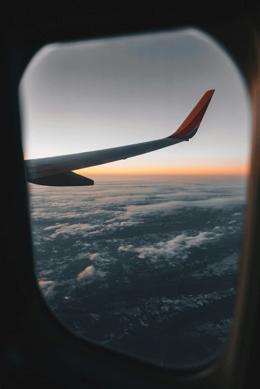 the view out of an airplane window looking outside of the wing