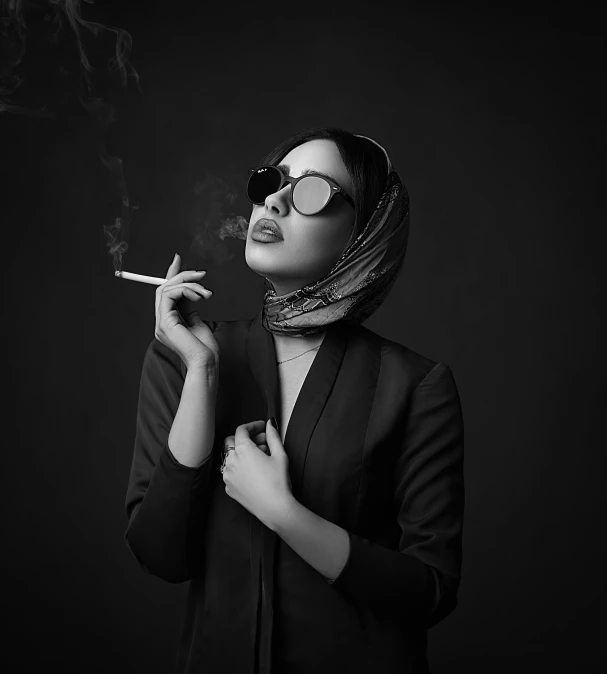 a woman smoking a cigarette in the dark