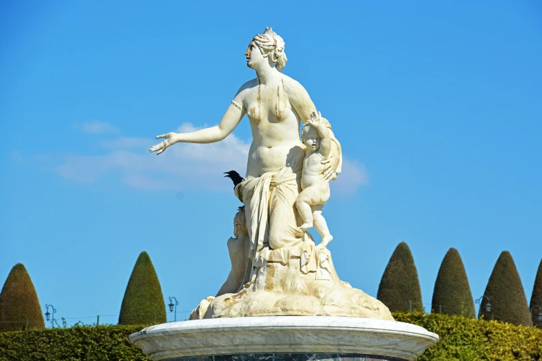 a very large beautiful statue near many bushes