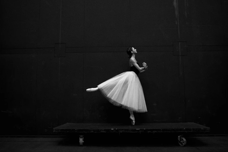 a black and white image of a ballerina dancing