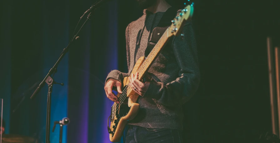 a man that is standing in front of a microphone