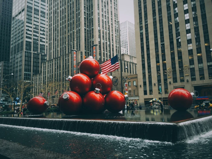 a big statue with red balls on top