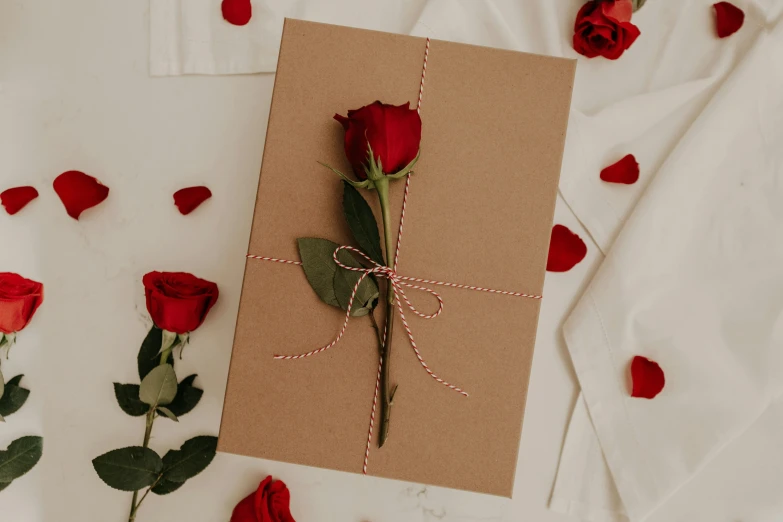 a rose is placed on top of the card and tied with twine