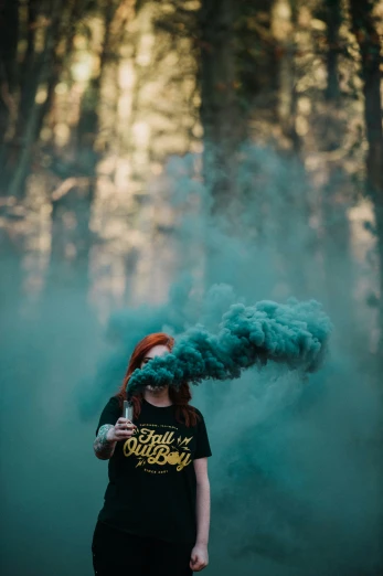 a woman smokes an orange flower as she stands in front of some blue smoke
