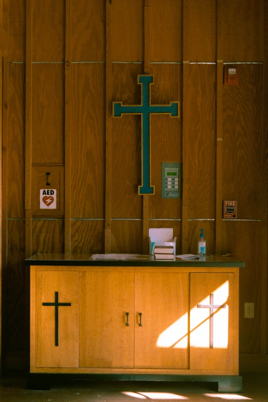 a wooden wall with crosses on it next to another wooden counter
