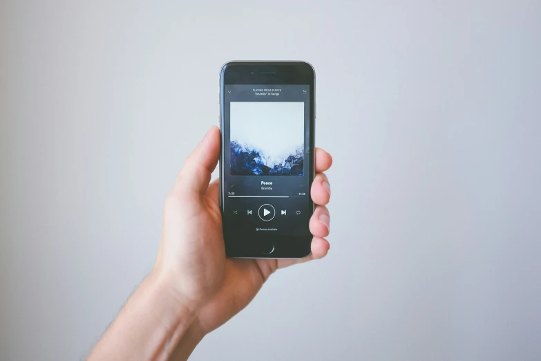 someone holding a black phone in their hand