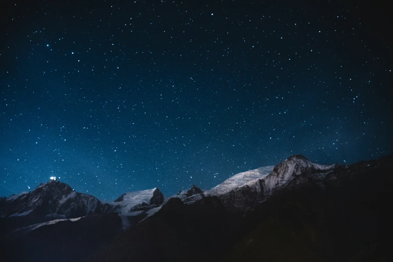 some very beautiful snowy mountains covered in stars