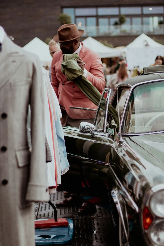 men's coats are hung up in the rain outside