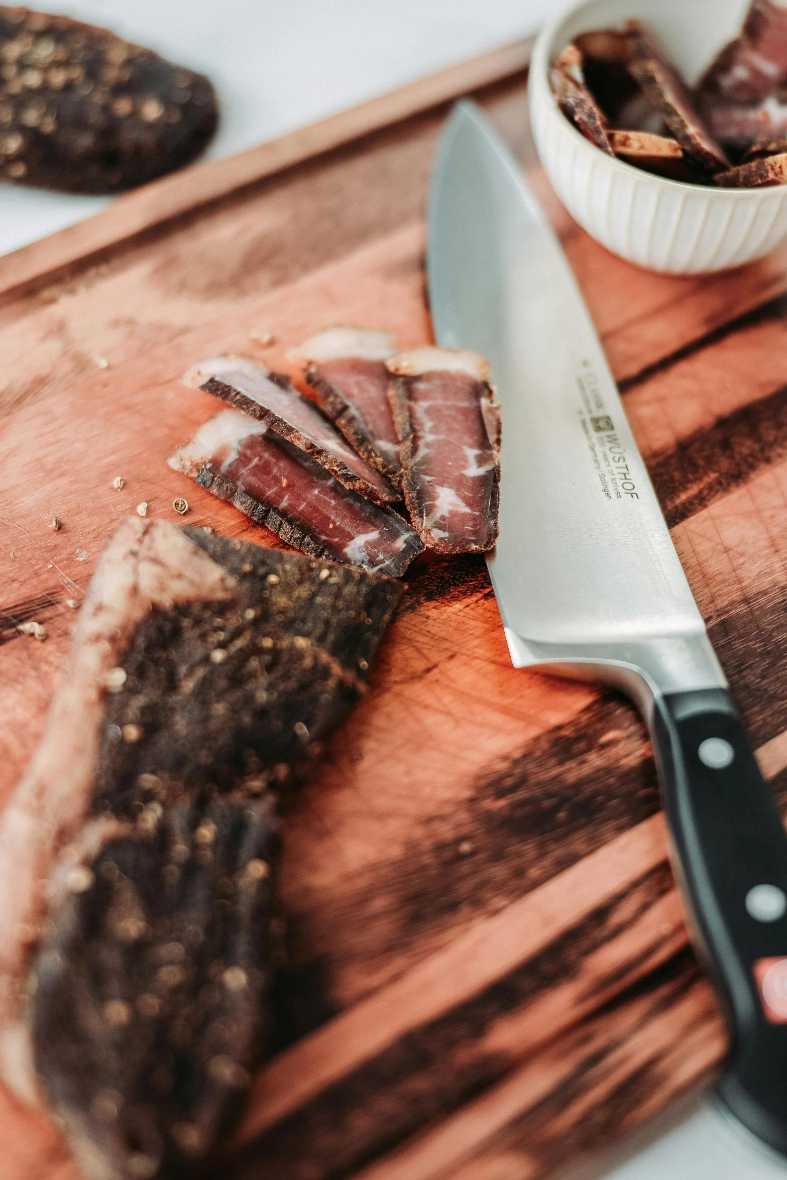 a knife and some meat sitting on top of a  board