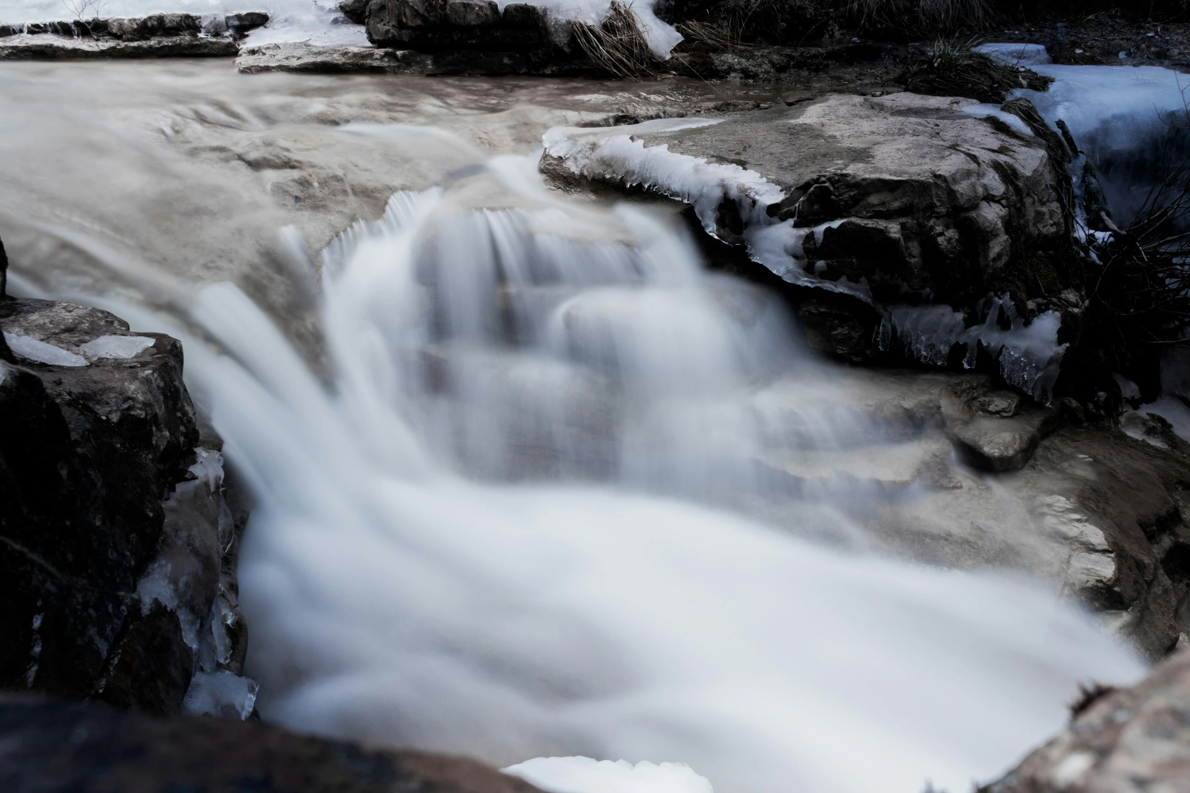 a very large waterfall in some very snowy terrain