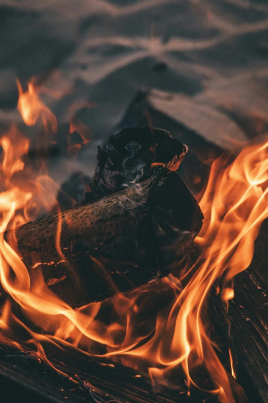 flame and flame sticks in front of a wooden surface