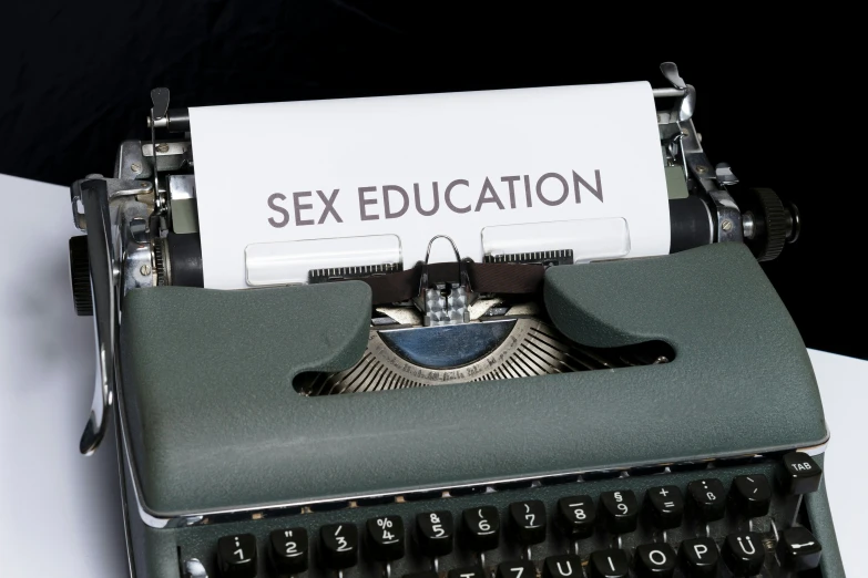 a picture of sex education and a typewriter