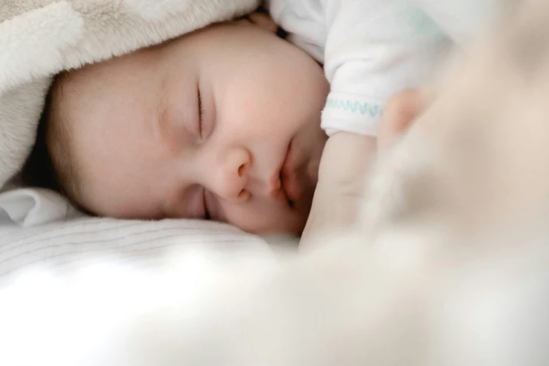 a newborn baby laying in his crib