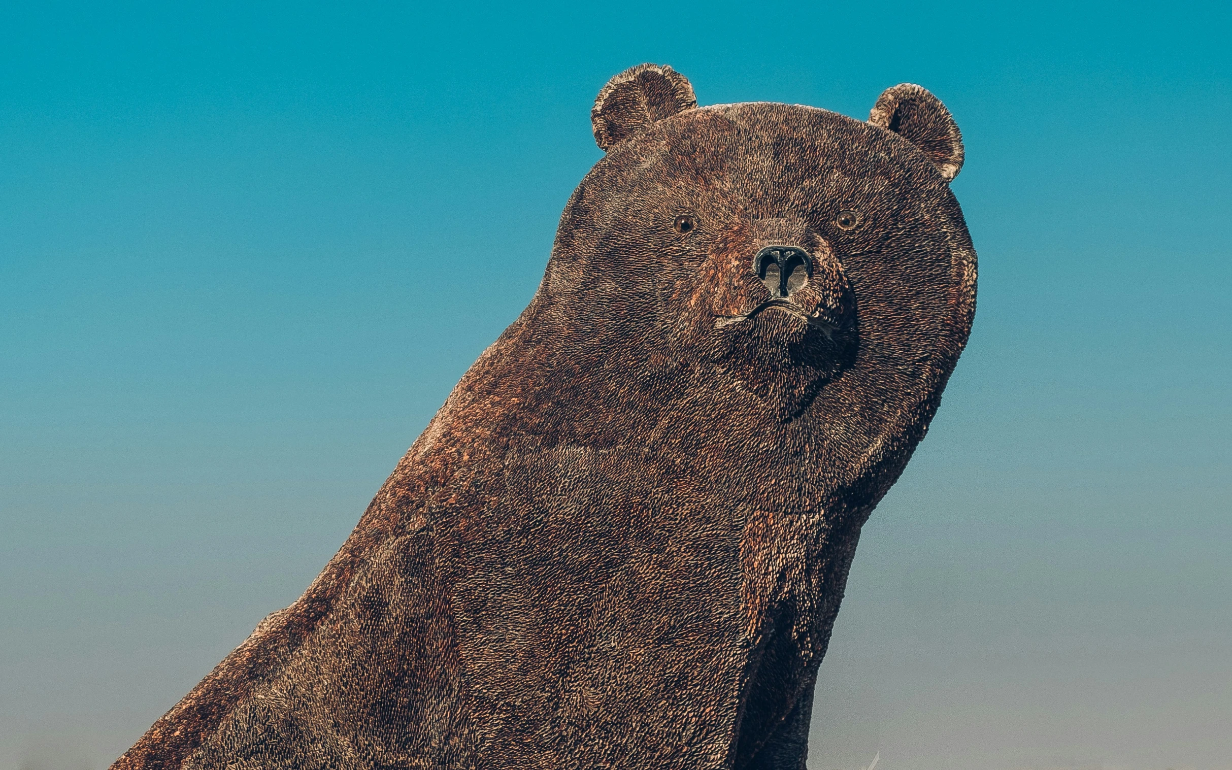 a giant bear statue that appears to be in the grass