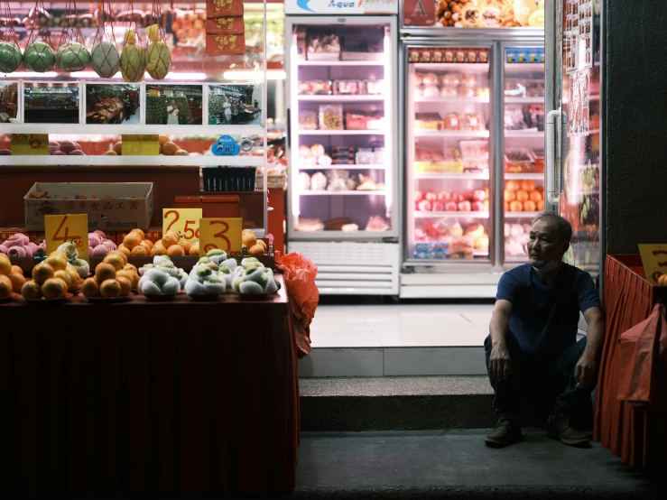 a man is kneeling down in front of a store