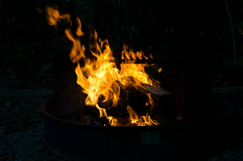 a fire pit lit up with bright yellow flames